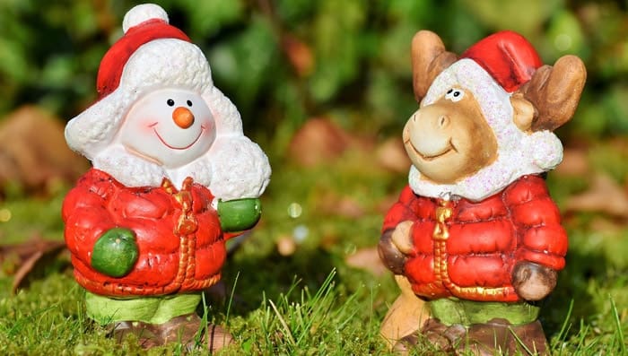 Two snowman reindeer statuettes on garden